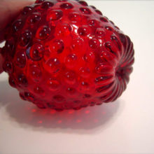 There are no seams in this ruby glass berry.