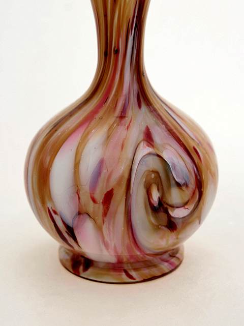 The Chalcedony Victorian art glass vase stands 10" tall and 5" at widest. Vase opening is 1.5" wide. Weighs 1.5 lbs. Unmarked.