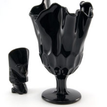 Black Depression glass vase stands 8" tall with hand-pulled ruffles to effortlessly arrange handfuls of flowers or grasses.