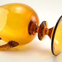 The applied handle is solid twisted glass. The dramatic wafer stem and inverted foot were formed separately and applied to the large mouth blown vessel.