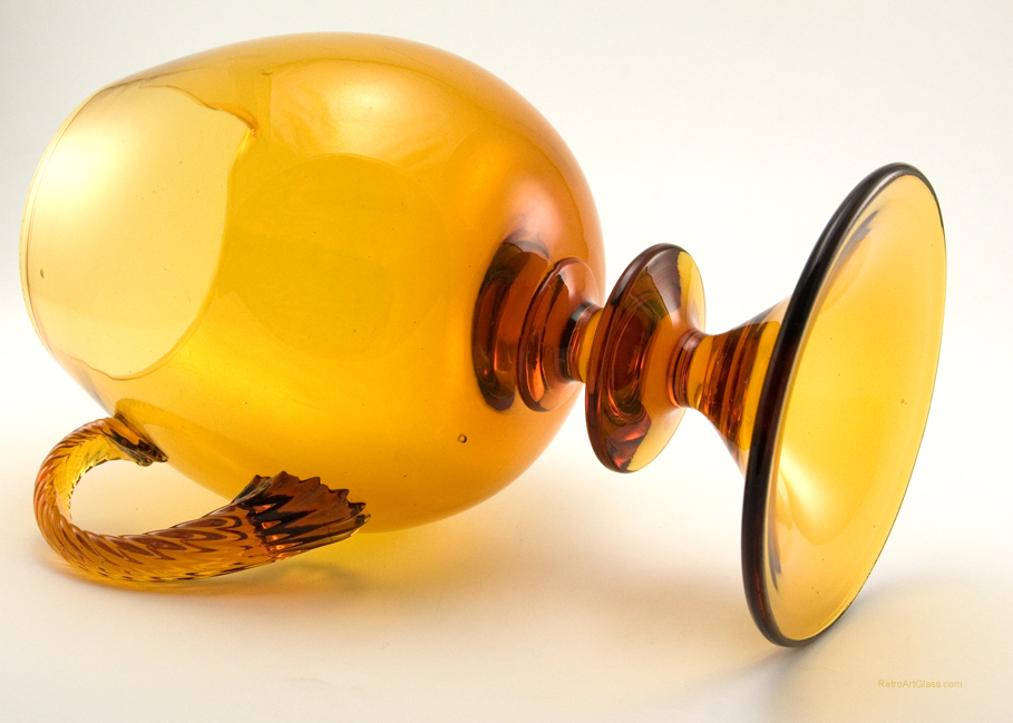 The applied handle is solid twisted glass. The dramatic wafer stem and inverted foot were formed separately and applied to the large mouth blown vessel.