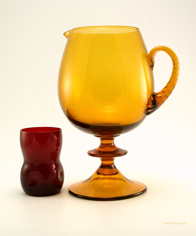 Jetson style Space Age decor pitcher made in the 1960's with thick luscious amber colored glass. This big mod beverage pitcher was mouth-blown and hand-formed.