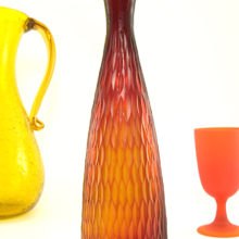 Attention grabbing carved art glass bottle vase looks stunning when light shines through.