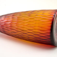 The carved art glass bottle rim was shaved off and hand polished flat.  The pontil scar was removed when the rim was shaved and polished.  The base was pressed flat.