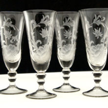 Beautiful Swedish blown glass goblets with deep hand-cut floral and fauna decor.