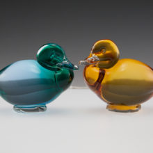 Vintage pair of Pauly & C glass resting ducks with red and white inventory label still attached.