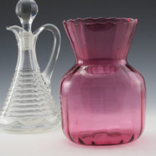 This vase has a deep, rich cranberry color with fairly thin blown optic glass.