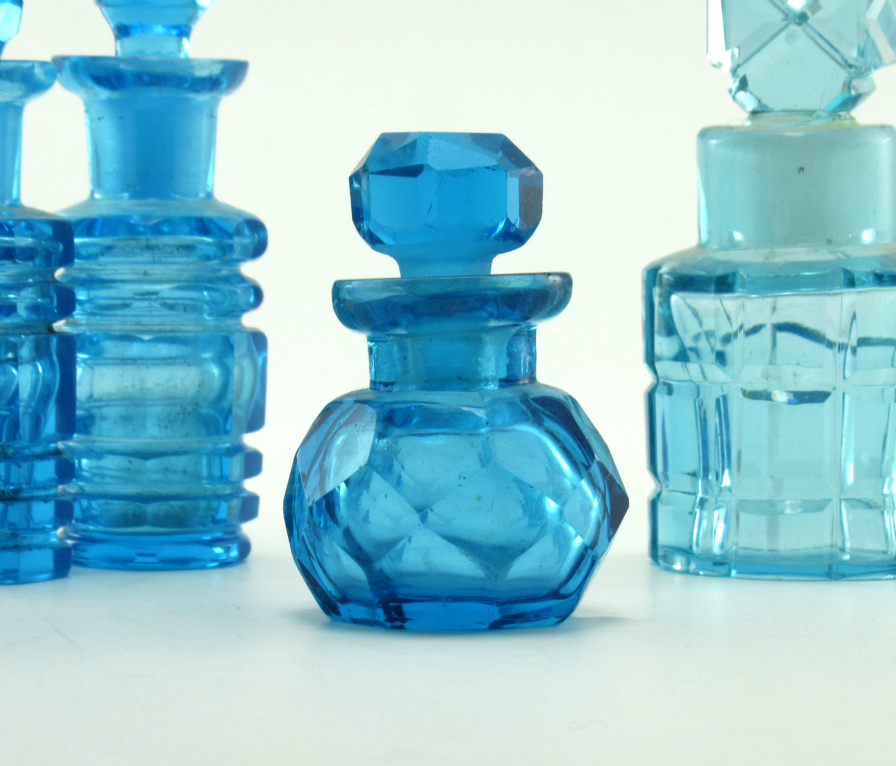 Beautiful round faceted blue glass perfume bottle made in France.