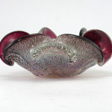 This luxurious vintage Venetian glass bowl is made of jewel-like glass internally decorated with real silver. Cased in amethyst and colorless crystal with silver foil veil sandwiched between. Looks like an exotic jewel.