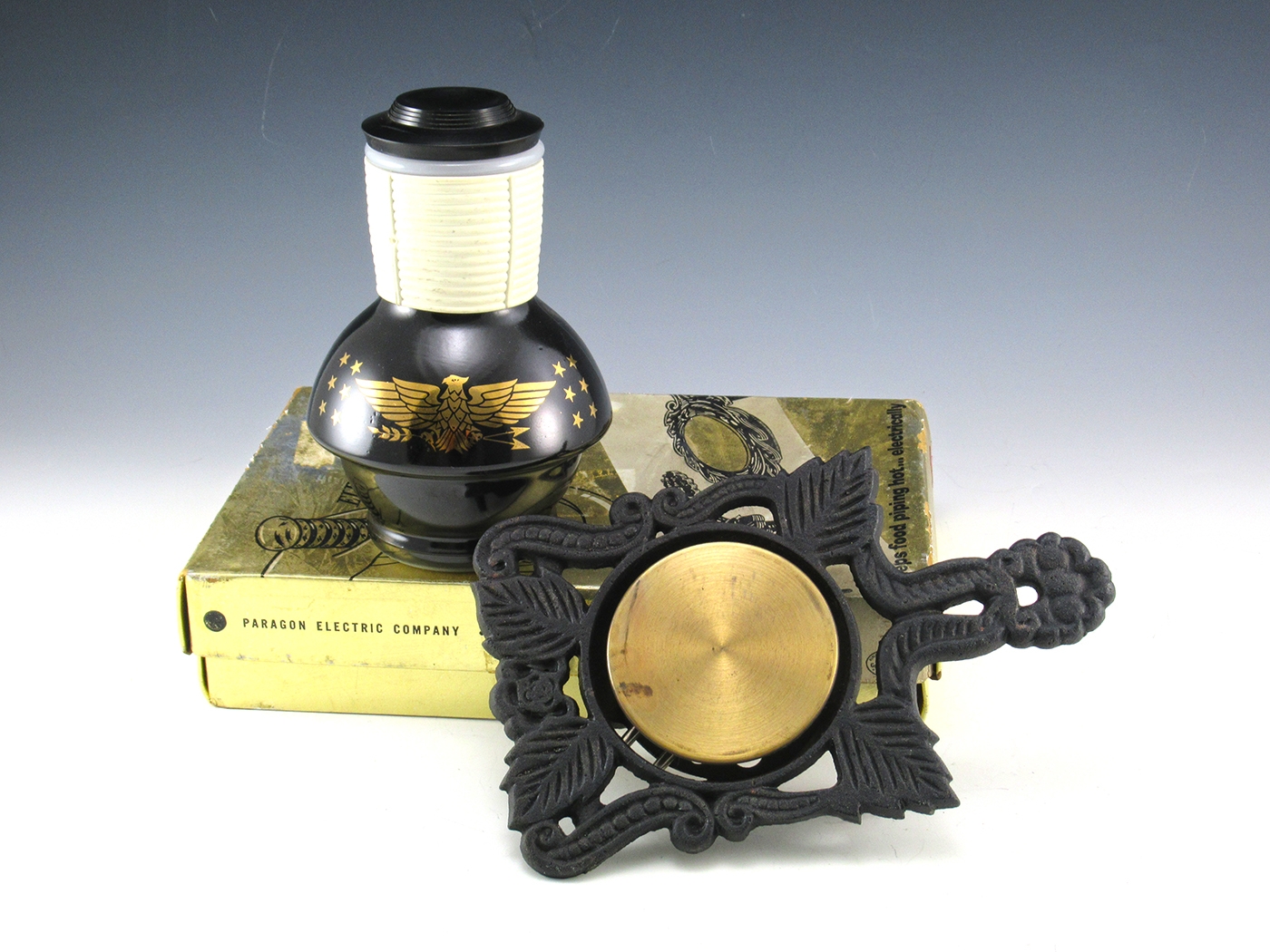 The iron ElecTrivit in unused in original box. There is atmosphere discoloring on the brass metal warmer, does not effect it's performance. Included in the box is the original, never used plug and cord and instruction manual.