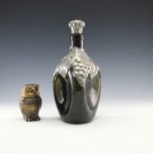 Vintage Danish glass pinched decanter made of dark avocado green glass with pewter collar and stopper. Marked on pewter grape decor collar "Pewter Made in Denmark".