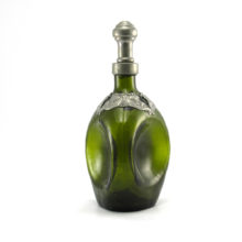 This fascinating Danish glass decanter was produced in the 1960's when old world decor in the fashion of Henry VIII was in style. Back in the days of the Henry VIII, glass was rare and usually brown or green. Pewter was the metal of choice.