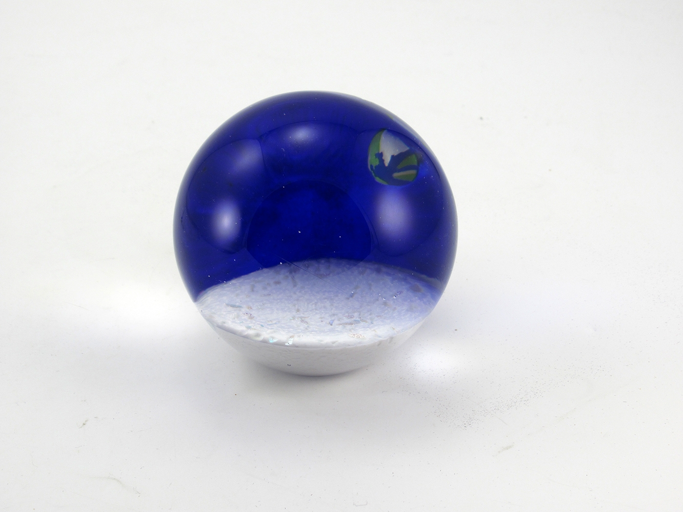 Earth Rising paperweight hand-made by Glass Eye Studio (USA). Part of the Celestial Series, a group of utterly fascinating paperweights depicting the Universe and its celestial inhabitants. The Earth Rising paperweight is retired and very hard to find.