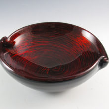 Stunning vintage Murano art glass bowl in cased black and colorless crystal glass with red aventurine inclusions. The sparkling inclusions were swirled from the rim to the base and it glitters like fire. Spectacular eye-catcher.