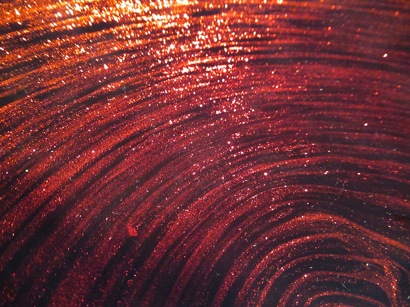 Particles of red aventurine sandwiched between jet black and colorless crystal evoke the illusion of fire.