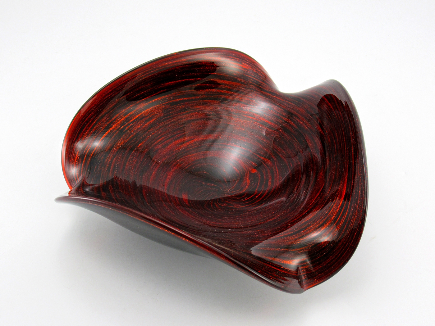 Fascinating vintage Murano glass bowl in cased black glass with red aventurine inclusions. The inclusions were swirled from the rim to the base and it glitters like fire.
