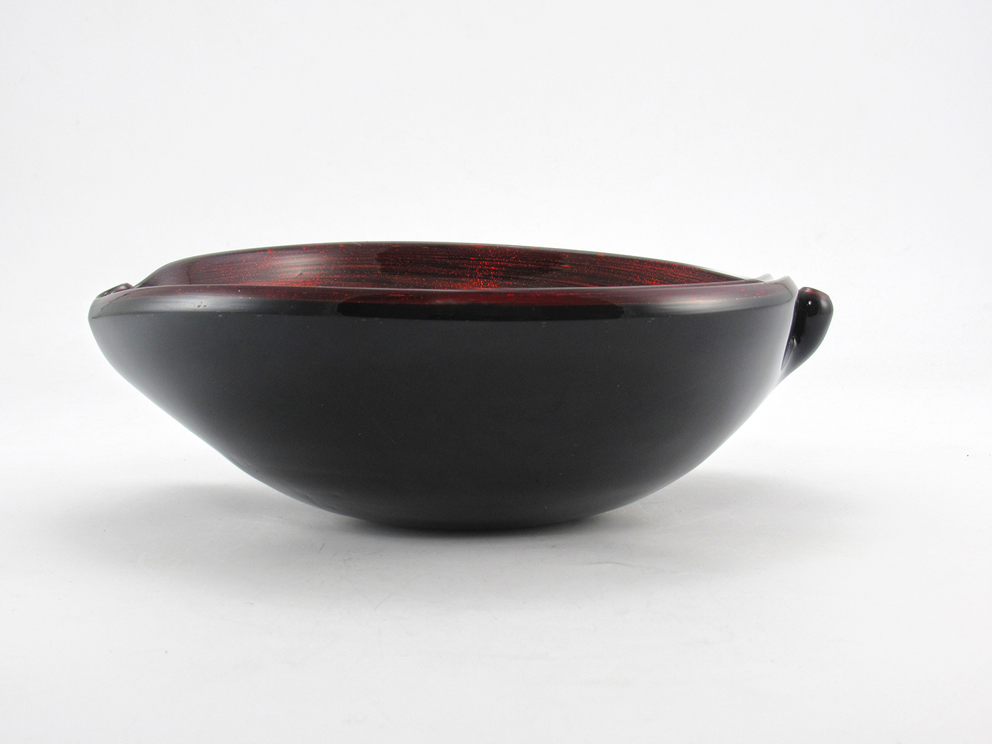 We believe this bowl was probably produced during the Mid-Century modern period, estimated circa 1940 to 1960. Made by hand. Thick, high quality vintage leaded glass in solid black encased in colorless crystal. The fire red aventurine is sandwiched between.
