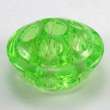 Small Uranium glass flower frog made in or around 1916 for assistance in flower arranging. This small domed frog, perfect size for a bud vase, was made of Uranium glass which fluoresces bright glowing green under ultraviolet (black) light.