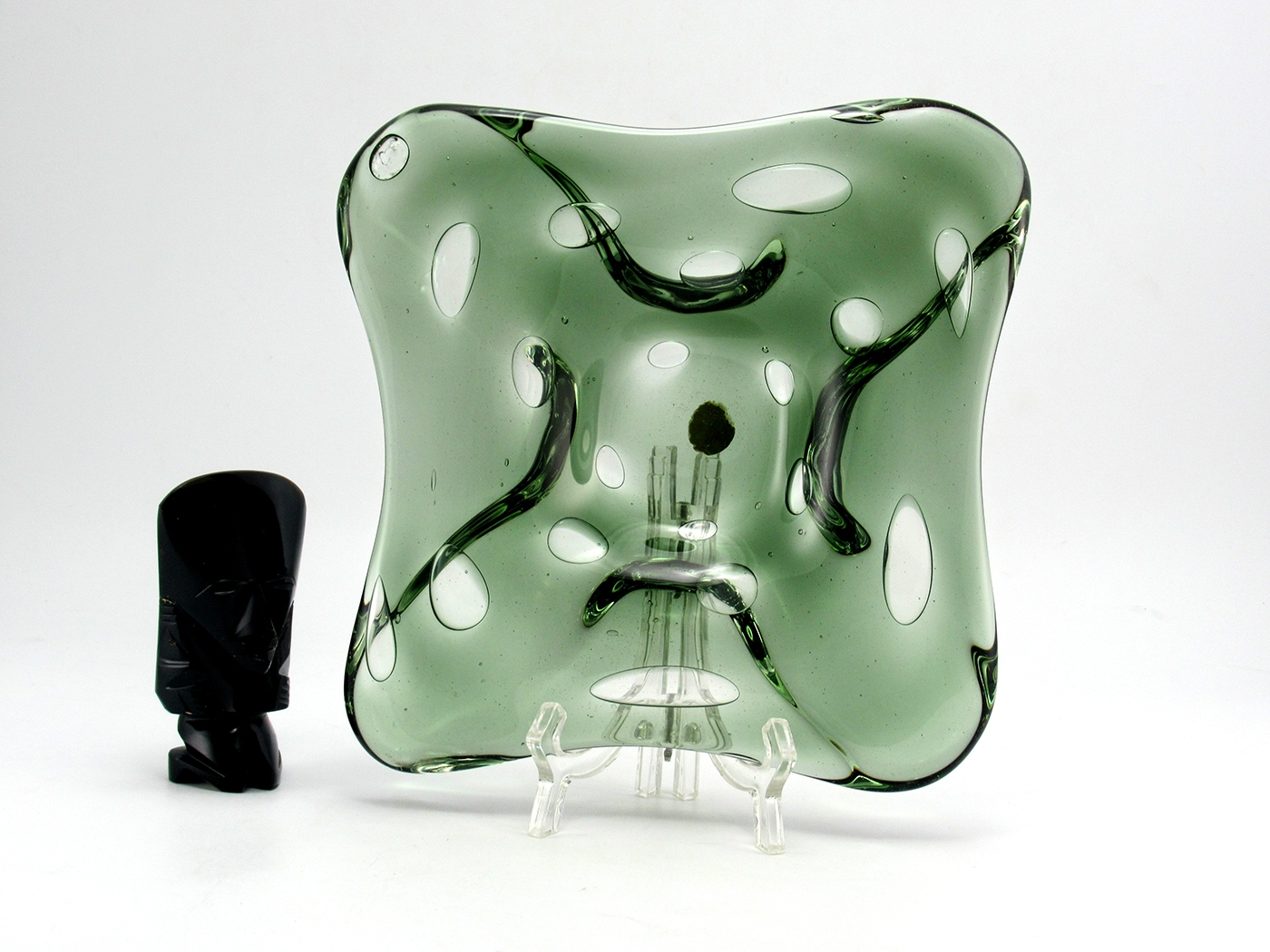 The elongated bubbles were blown into the hand-formed glass by blowpipe. The bubbles create areas of colorless glass. Original and very unique.