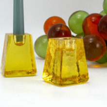 Signed candlestick holders hand-made in solid lemon-yellow vintage glass. The exterior is decorated with hand-tooled chisel marks. Candle holder fits taper size candles.