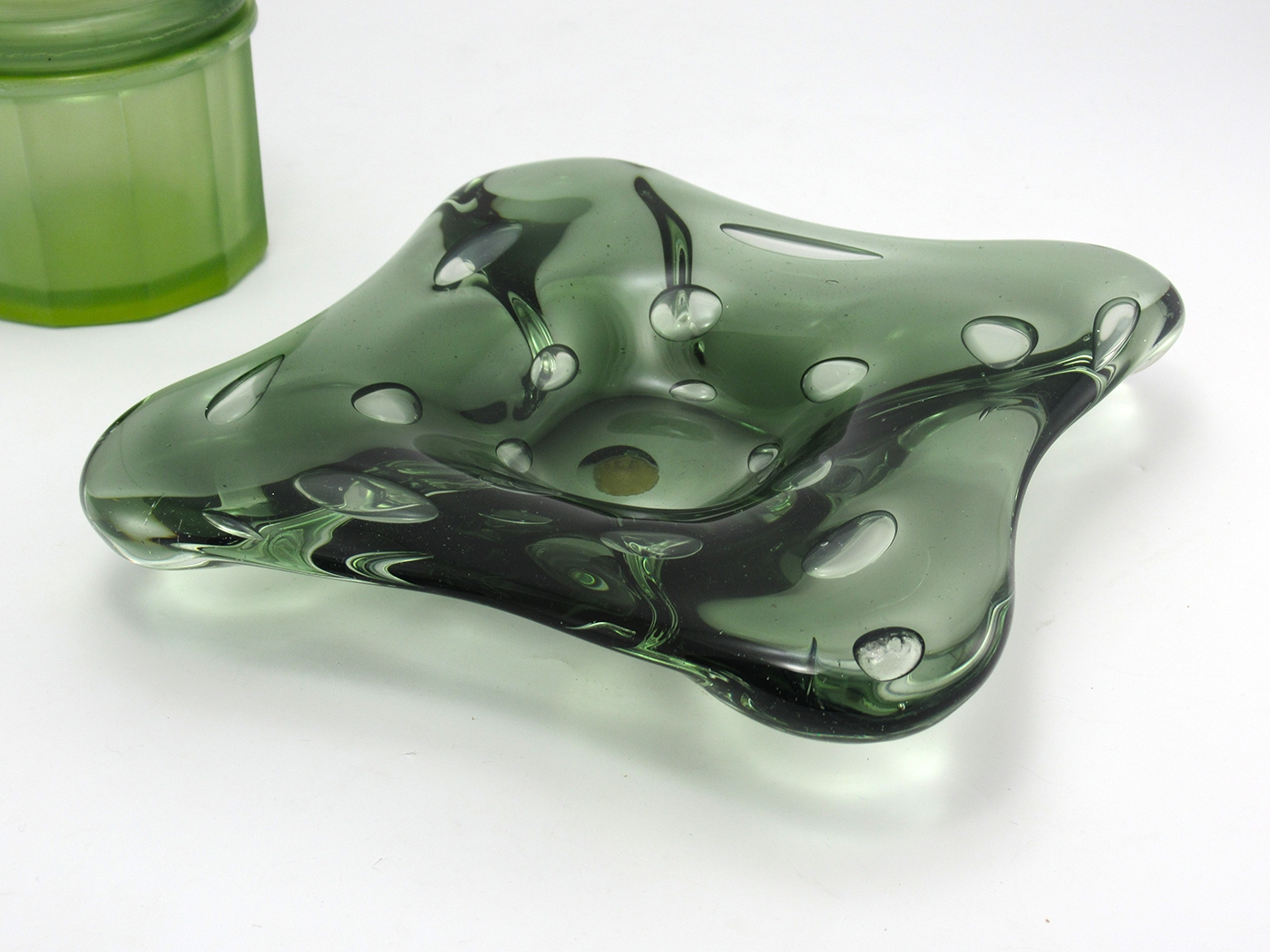 Toso art glass bowl mod Mid-20th Century Modern design. The color also matches the mid-century modern style. It's a translucent smoked green, greenish/black.