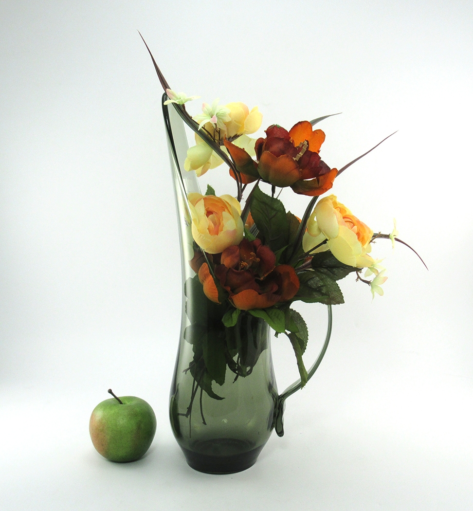 The form is exceptional for flower arranging. The long spout and elaborate handle provide draping areas for flowers.