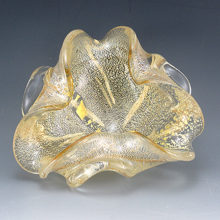 Mid-Century Italian art glass bowl hand-made in colorless glass with abundant gold leaf veils trapped inside.