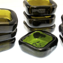 Erik Hoglund for Boda Viking dishes. Nine are in olive green and one is in forest green. Measure 1½ square. Hoglund used them in his lighting fixtures designs.  But they were also offered as little dishes with multiple uses.