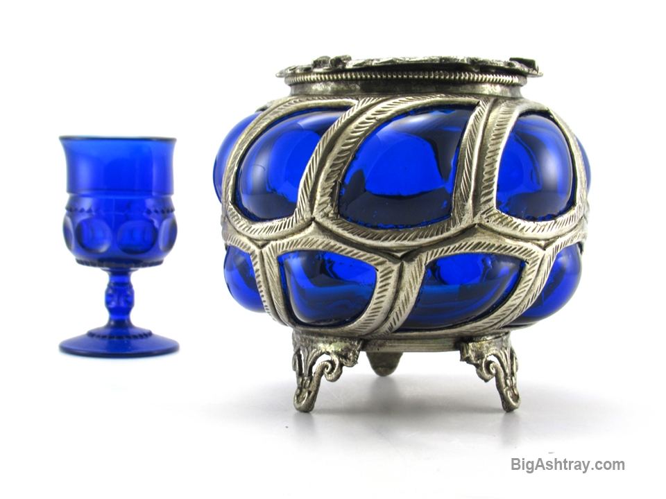 Antique Cobalt Blue caged glass hand-blown into metal. Beautiful deep cobalt blue glass blown into hand-formed metal.