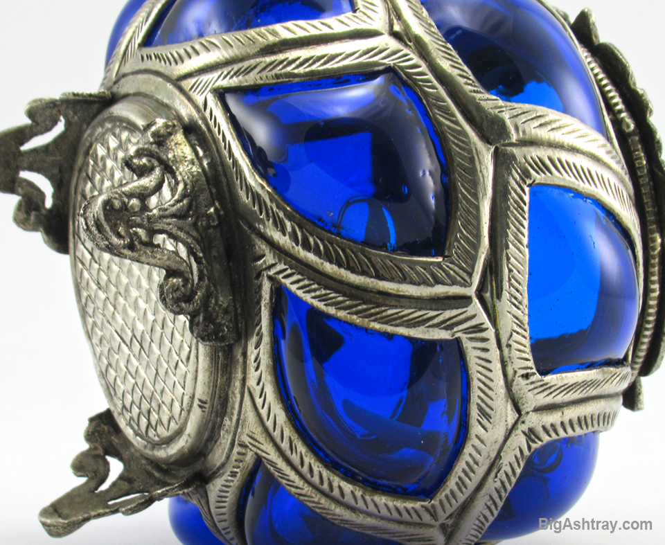 This hand blown caged glass ashtray bowl is made with solid metal, not plated. It is non-ferrous metal, a magnet will not stick to the metal.