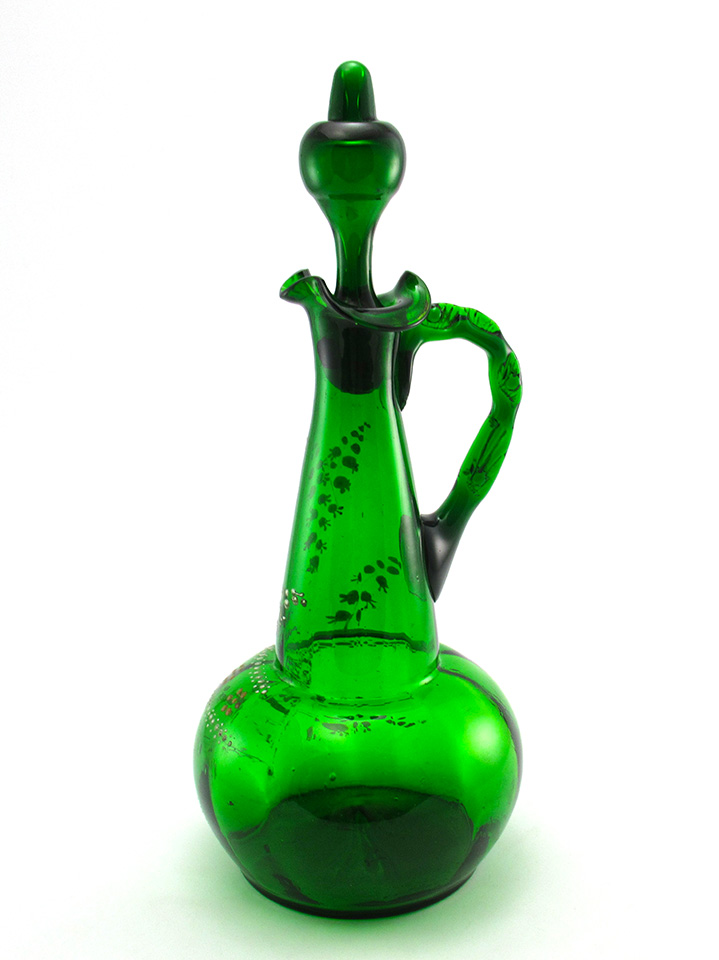 Large antique glass decanter in emerald green with enamel decor measures 13" tall with stopper.