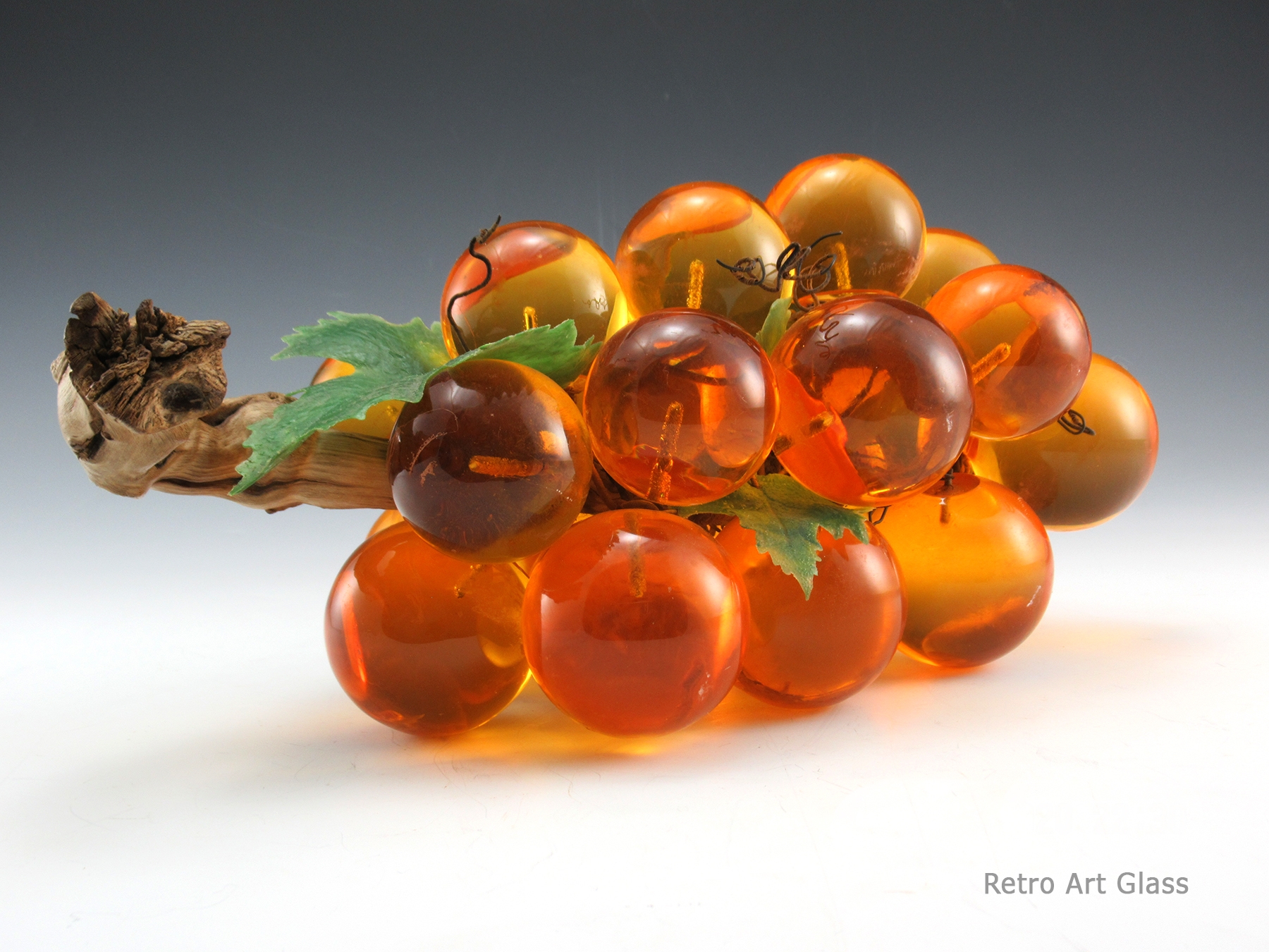 Still retains its original green leafs and original wiring. Wiring is in great condition. The driftwood log is perfect and clean. Big orange grapes have very little scratching.