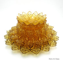 This distinctive pattern is call Petal #2829.  In beautiful light amber glass called Sungold. Set of 16 consists of (2) 11.5″ platter/dinner plates, (4) 9″ dinner/salad plates, (5) 6.5″ liner or bread plates, and (3) 5.5″ sauce/service bowls.