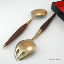 Mid-Century Modern Serving Utensils Made in Hong Kong. Both in excellent condition. Appears to be unused. Includes original box with red velvet lining and black tortoise outer. Box is marked "Made in Hong Kong".