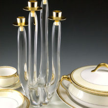 Swedish Modern glass candelabra. The four candle stick arms were hand-drawn from molten colorless, high quality glass/crystal. The candle cups are made with gold chromed metal in excellent condition. Looks new, but it is of a least vintage age. Probably made in the 1960's or 1970's. Signed by artist.