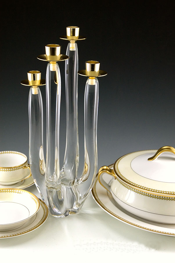 Swedish Modern glass candelabra. The four candle stick arms were hand-drawn from molten colorless, high quality glass/crystal. The candle cups are made with gold chromed metal in excellent condition. Looks new, but it is of a least vintage age. Probably made in the 1960's or 1970's. Signed by artist.