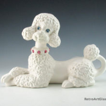 Signed Fi Fi and dated 1966 on base. Well groomed poodle with glass jewel eyes and collar adornment.