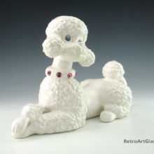 Signed Fi Fi and dated 1966 on base. Well groomed poodle with glass jewel eyes and collar adornment.